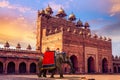 Decorated Indian elephant in front of Buland Darwaza Fatehpur Sikri Agra India at sunset.