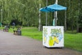 Decorated lemonade stand in park. Summer refreshing natural drink. White lemonade stall with tent and cranes. White street stall