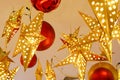 Decorated lighting golden stars and big red Christmas balls hanged on ceiling in the room for ready on the Christmas night party Royalty Free Stock Photo