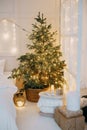 Decorated mirror and live Christmas tree with lights. New year's interior, festive atmosphere, decor, garlands