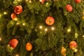 Natural Christmas tree decorated with apples and oranges fruits. Christmas background. New Year postcard. Royalty Free Stock Photo