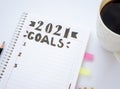 Decorated notebook for writing New Year's resolutions on a table and a coffee cup on the sid Royalty Free Stock Photo
