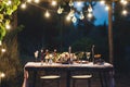 Decorated outdoor wedding table with flowers in rustic style