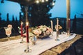 Decorated outdoor wedding table with flowers in rustic style