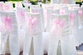 Decorated with pink bows on the chairs wedding ceremony Royalty Free Stock Photo