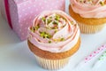 Decorated pink cup cakes with pistachio nut sprinkles - Birthday Royalty Free Stock Photo