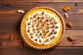 Decorated pumpkin tart with nuts on a wooden background, top view