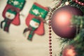 Decorated red ball on Christmas tree with socks at background Royalty Free Stock Photo