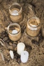 decorated romantic place for a date with jars full of candles standing on a sand