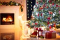 Decorated room with Christmas tree and fireplace