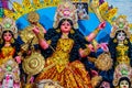 Decorated sculpture of goddess Durga idol on lion with ten arms at pandal and temple in colored light. Durga Puja is big cultural