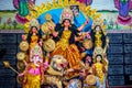 Decorated sculpture of goddess Durga idol on lion with ten arms at pandal and temple in colored light. Durga Puja is big cultural