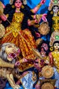 Decorated sculpture of goddess Durga idol on lion with ten arms at pandal and temple in colored light. Durga Puja is big cultural