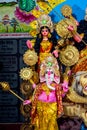 Decorated sculpture of goddess Durga idol on lion with ten arms at pandal and temple in colored light. Durga Puja is big cultural