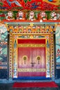 Decorated, with a skillfully made and ornate doorknobs entrance to a temple of the Rumtek Buddhist monastery