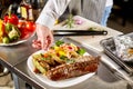 Decorated with a sprig of rosemary. the chef prepares in the restaurant. Grilled rack of lamb with fried potatoes and Royalty Free Stock Photo