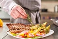 Decorated with a sprig of rosemary. the chef prepares in the restaurant. Grilled rack of lamb with fried potatoes and Royalty Free Stock Photo