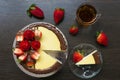 Decorated strawberry cheesecake with a cup of tea and strawberries