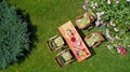 Decorated table with cheese, strawberry and fruits in beautiful summer rose garden, aerial top view of table food and drinks Royalty Free Stock Photo