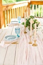 Decorated table for dinner for two person, with plates knife, fork, cheese, wine, wine glasses and flowers in a copper vase Royalty Free Stock Photo