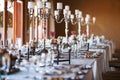 Decorated tables with candelabra at wedding reception, selective Royalty Free Stock Photo