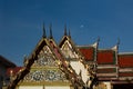 Decorated temple rooftop, wat benchamabophit, Bangkok. Blue sky and full moon in background.