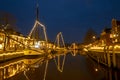 Decorated traditional boats in the harbor from Dokkum in Netherlands at christmas at night