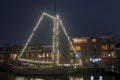 Decorated traditional sailing ship in the harbor from Harlingen in Netherlands in christmastime at night