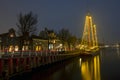 Decorated traditional sailing ship in the harbor from Harlingen in Netherlands in christmastime at night