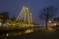 Decorated traditional sailing ship in the harbor from Harlingen in Netherlands in christmastime at night