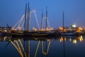 Decorated traditional sailing ship in the harbor from Harlingen in Netherlands in christmastime at night