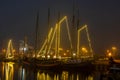 Decorated traditional sailing ships in the harbor from Harlingen in Netherlands in christmastime at night