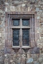 Decorated vintage window of an old stone building