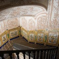 Decorated wall of a stone staircase.