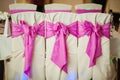 Decorated Wedding Chairs with Fabric and Pink Bow Royalty Free Stock Photo