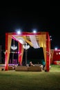 A decorated wedding gazebo in india with sofa seating and lighting