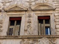 Decorated windows of the Palace of the Pupazzi in Via dei Banchi Vecchi to Rome in Italy.