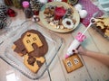 Decorating christmas gingerbread cookies with white glaze