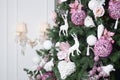 Decorating Christmas tree close up. Decoration bulb, fir tree, pink x-mas toys and lights. Use for Christmas and New years Royalty Free Stock Photo