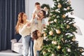 Decorating christmas tree. Family celebrating new year with their children at home Royalty Free Stock Photo