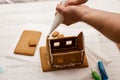 Decorating, cooking, slaking a gingerbread house. Preparation for Christmas Royalty Free Stock Photo