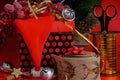 Decorating a gift with New Year\'s tinsel on a red background.