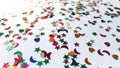 Decorating glitter sparkles in stars, heart and half moon shape stones with white background