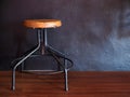 Decorating space room with round stool chair with black cement wall. Royalty Free Stock Photo