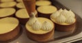 Decorating tartlets with cream using a culinary syringe