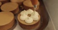 Decorating tartlets with cream using a culinary syringe