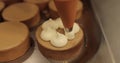 Decorating tartlets with cream using a culinary syringe