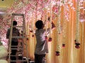 Decorating wedding reception hall at traditional Hindu wedding, India