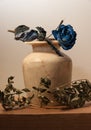 Decoration of an alabaster vase with blue roses Royalty Free Stock Photo