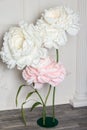 Decoration artificial Peonies on the stand on white hall background